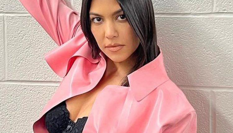 Pregnant Kourtney Kardashian shows off her baby bump in an elevator selfie

