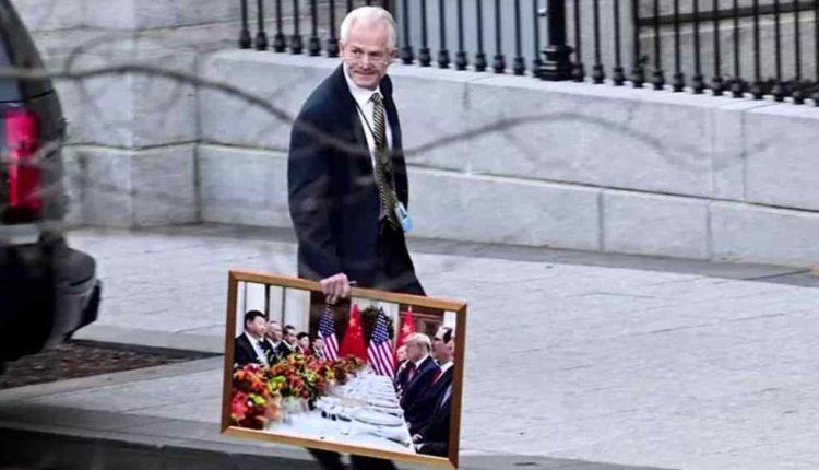 Peter Navarro takes a painting of Trump and Xi